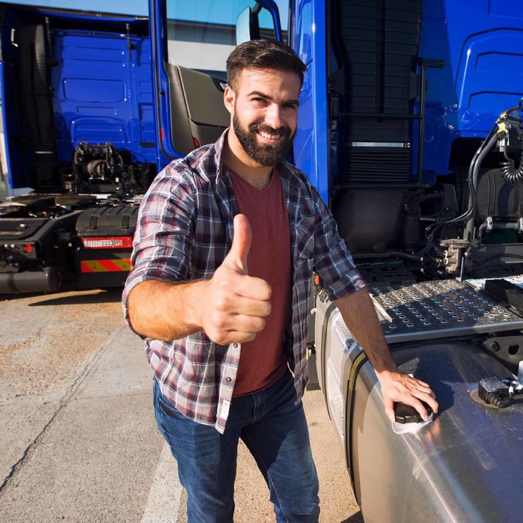 Trucker giving a thumbs up as he checks his truck